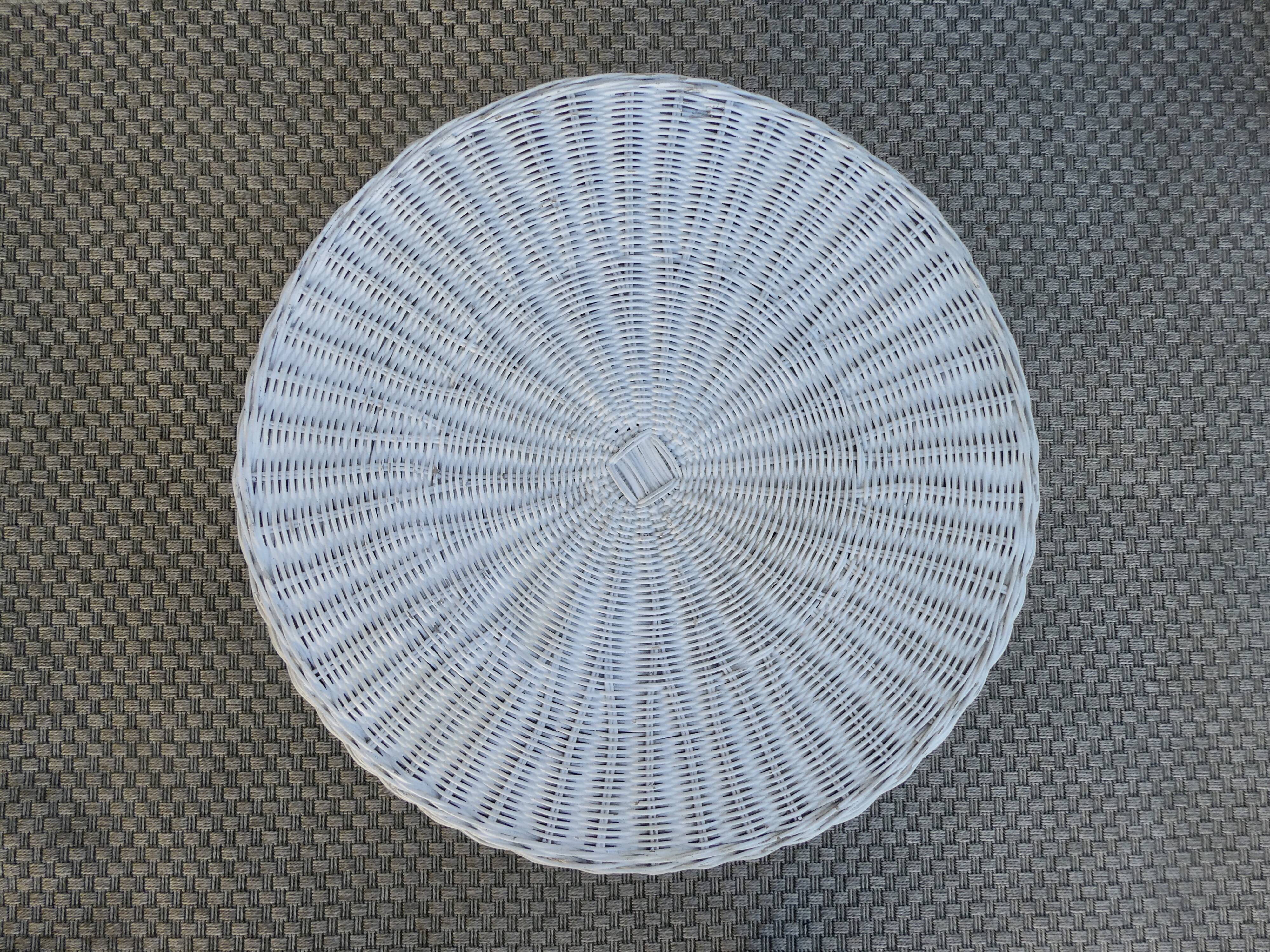 Round white rattan side table with storage underneath, circa 1970.