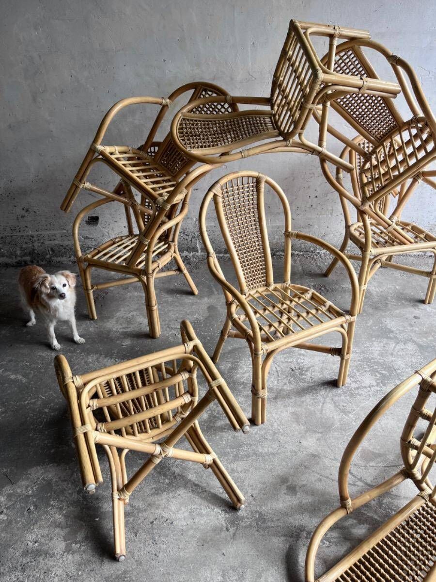Set of 8 Manou rattan chairs with cane backrest.