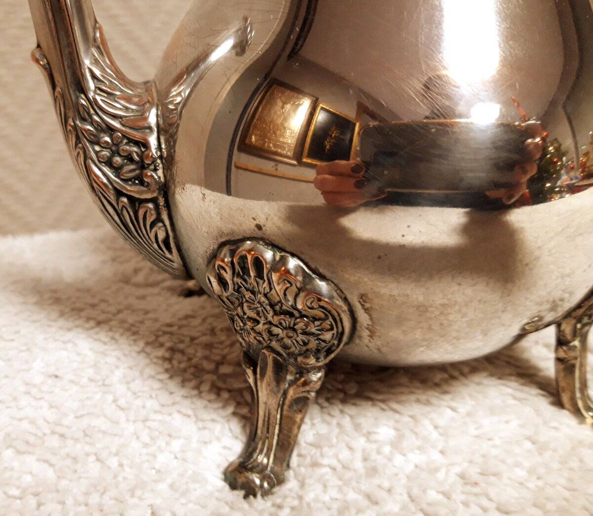 Silver-plated coffee and tea service including a coffee pot, a teapot, and a sugar bowl.