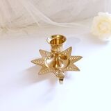 Golden brass hand candle holder decorated with leaves