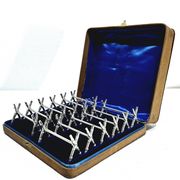 12 silver-plated metal knife handles, in a case.