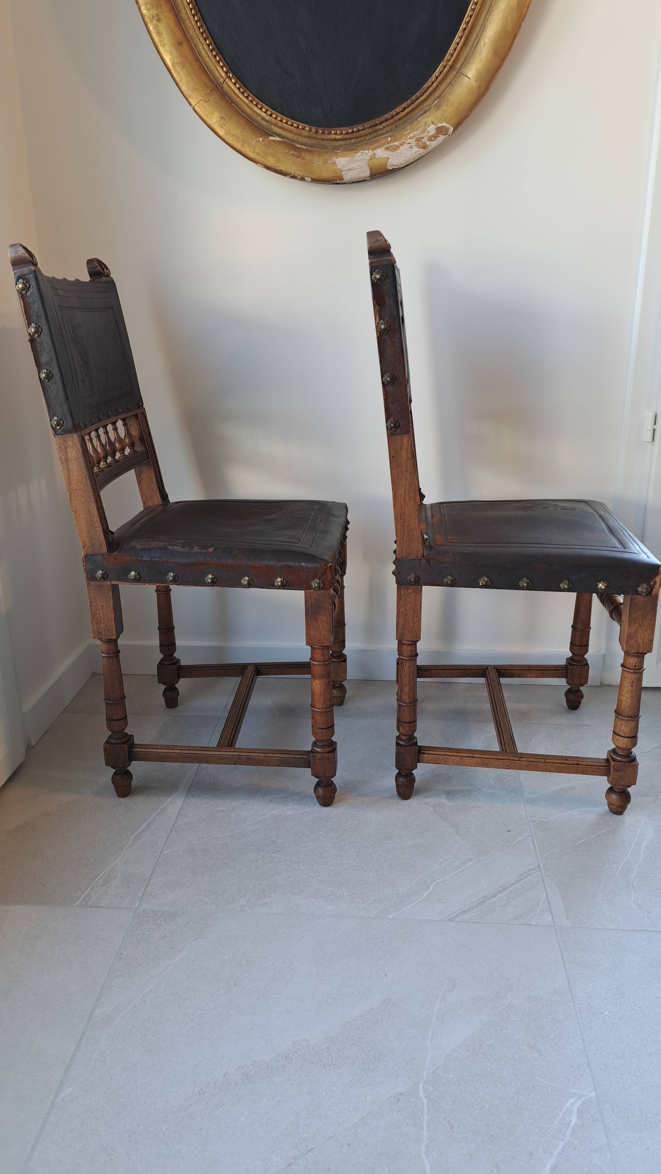 Pair of antique chairs in embossed leather, Henri II style.