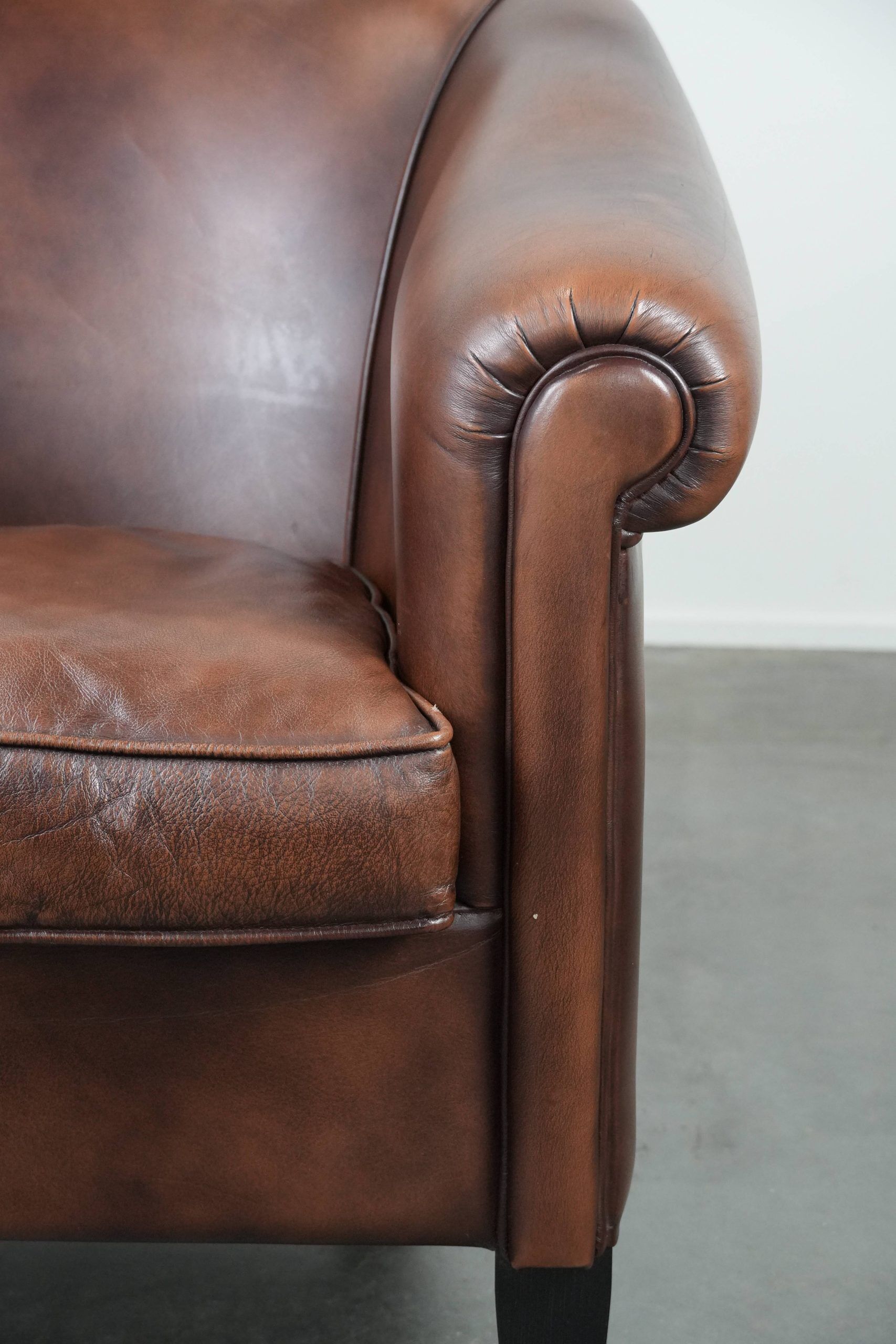 Great luxurious brown cowhide club armchair with matching piping