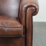 Great luxurious brown cowhide club armchair with matching piping