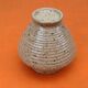 Glazed ceramic spinning top vase with speckled decor