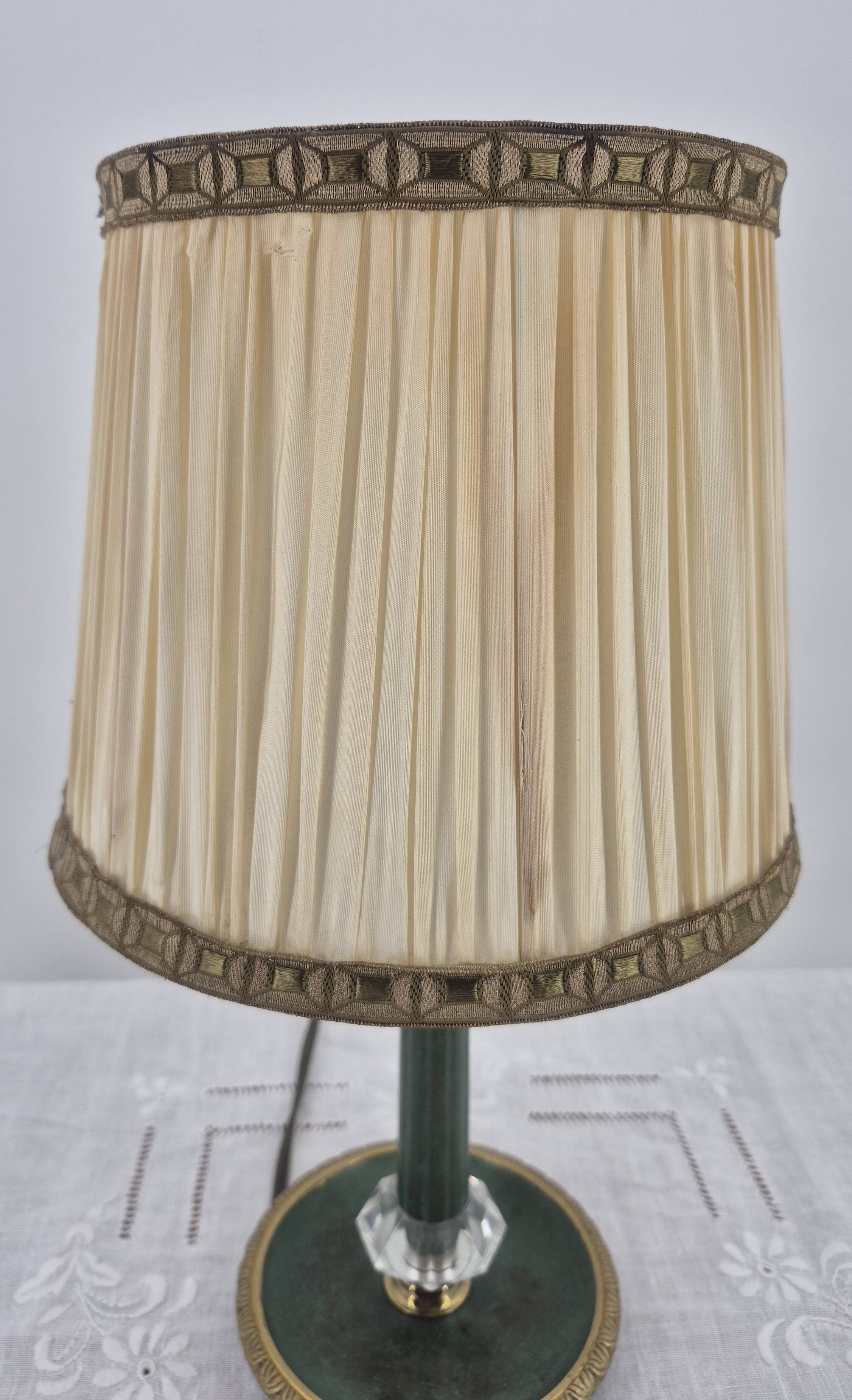 Brass table lamp with green patina and empire-style fabric shade.