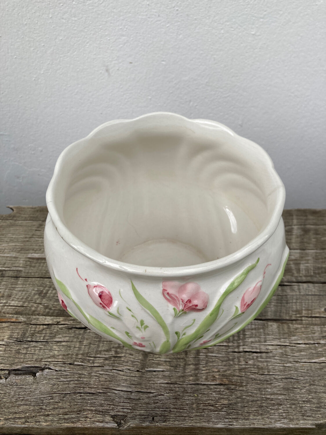 White ceramic pot cache in old flower slip