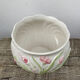White ceramic pot cache in old flower slip