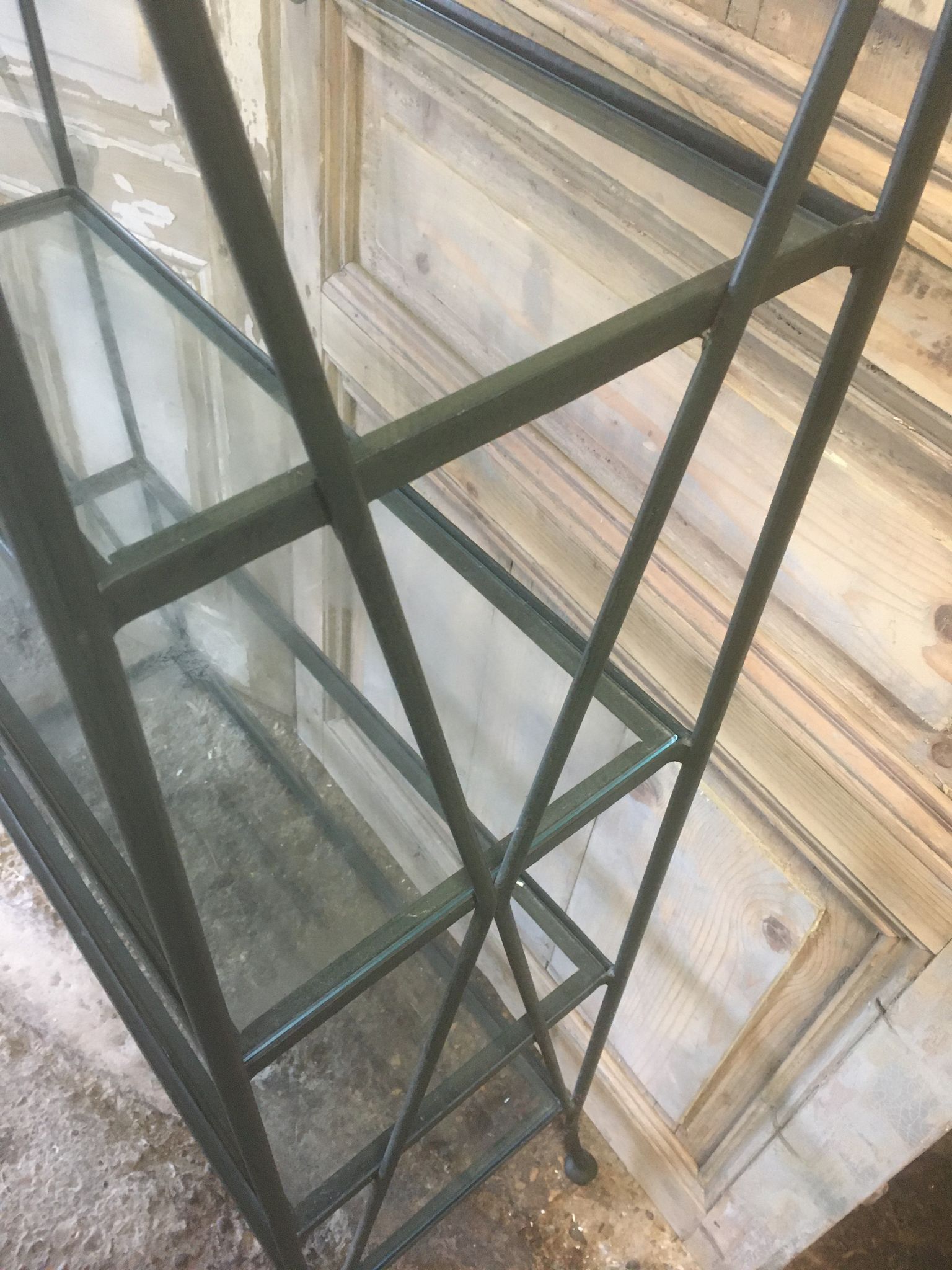 Pair of wrought iron and glass bookshelf shelves.