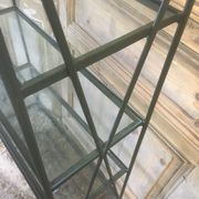 Pair of wrought iron and glass bookshelf shelves.