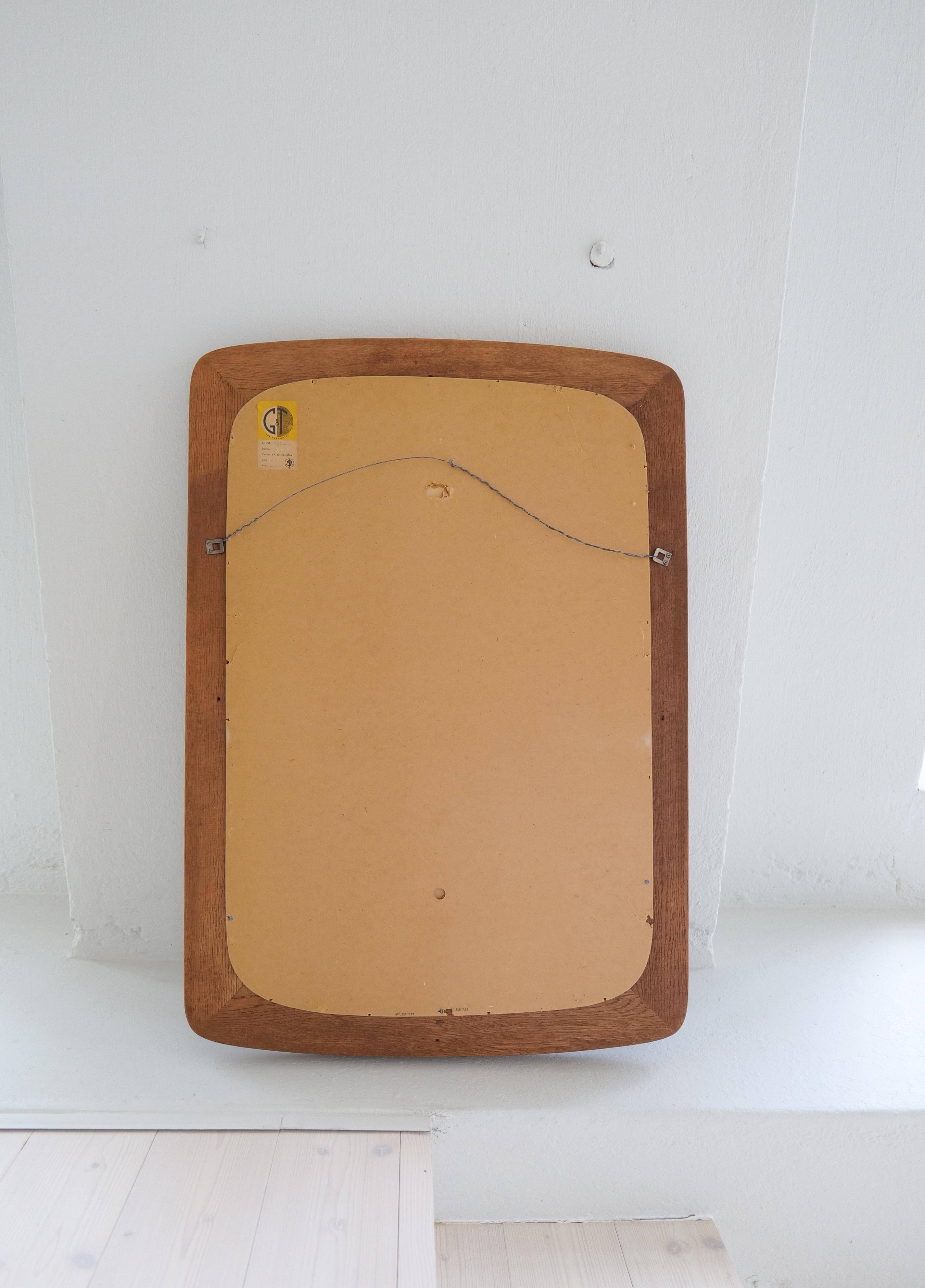 Mid-century modern sculptural wall mirror in stained oak, glass, Glas & Trä 1959