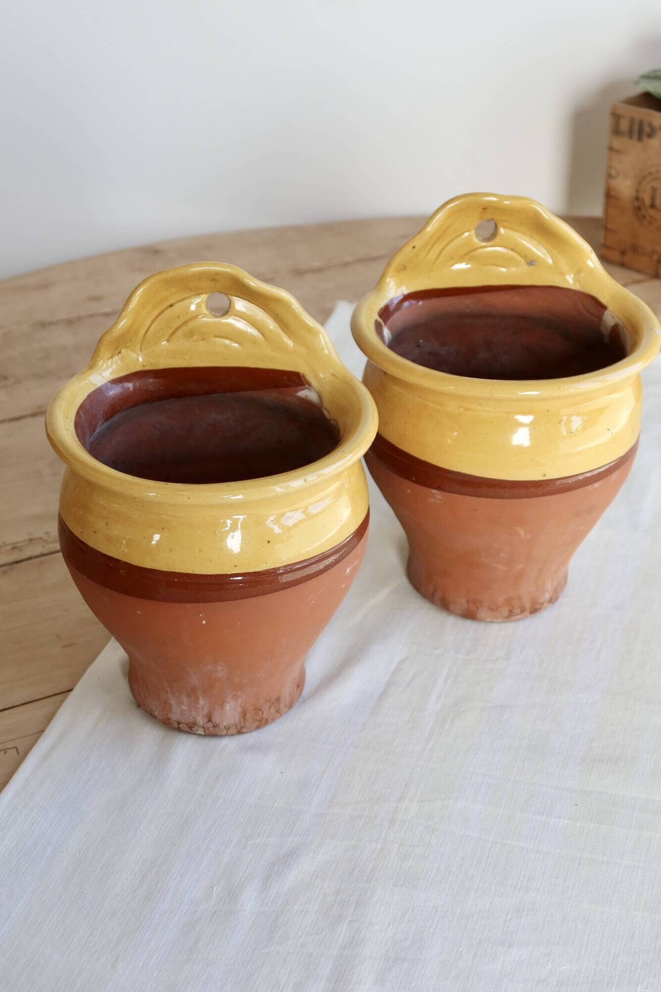 Pair of vintage wall planters in yellow glazed stoneware.