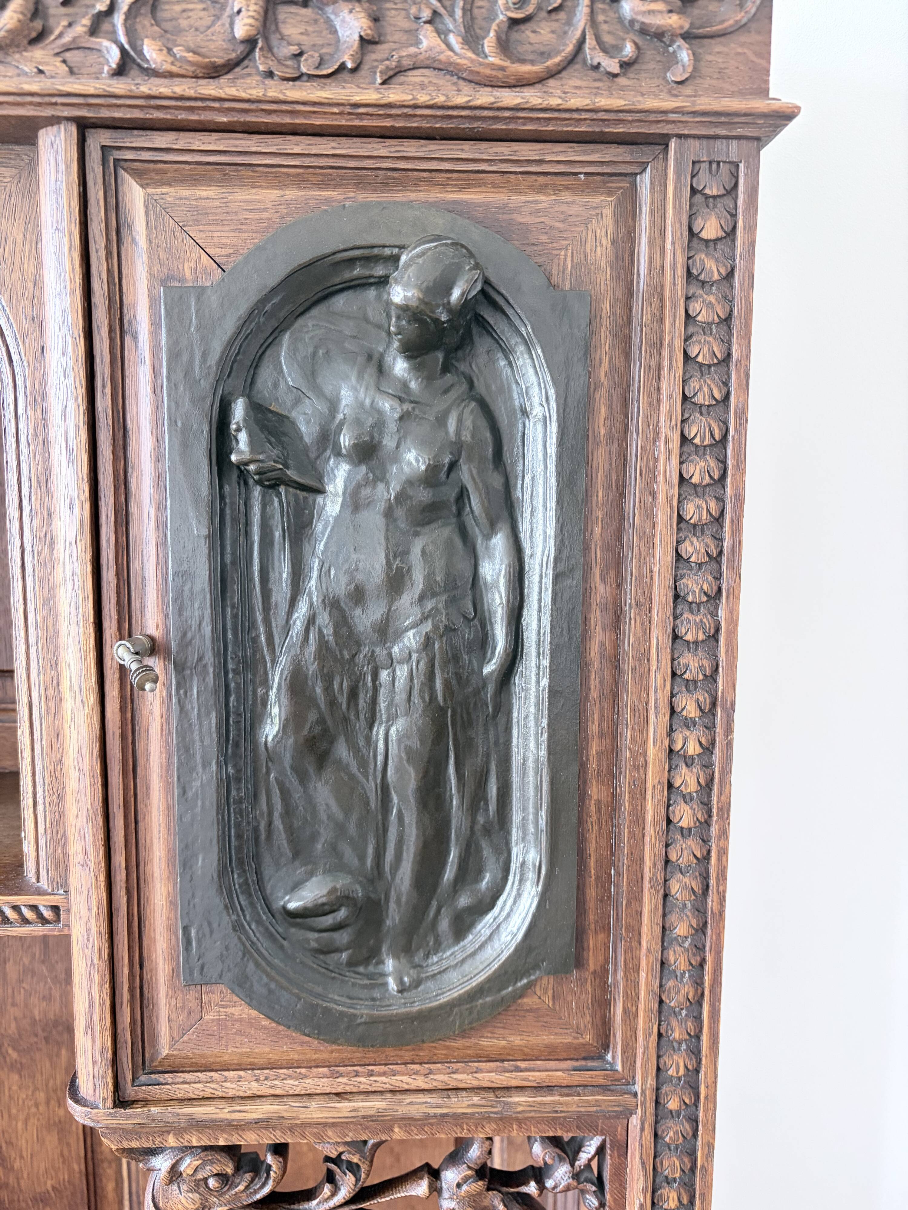 Large secretary with a drop-down front in carved oak, neo-Renaissance style.