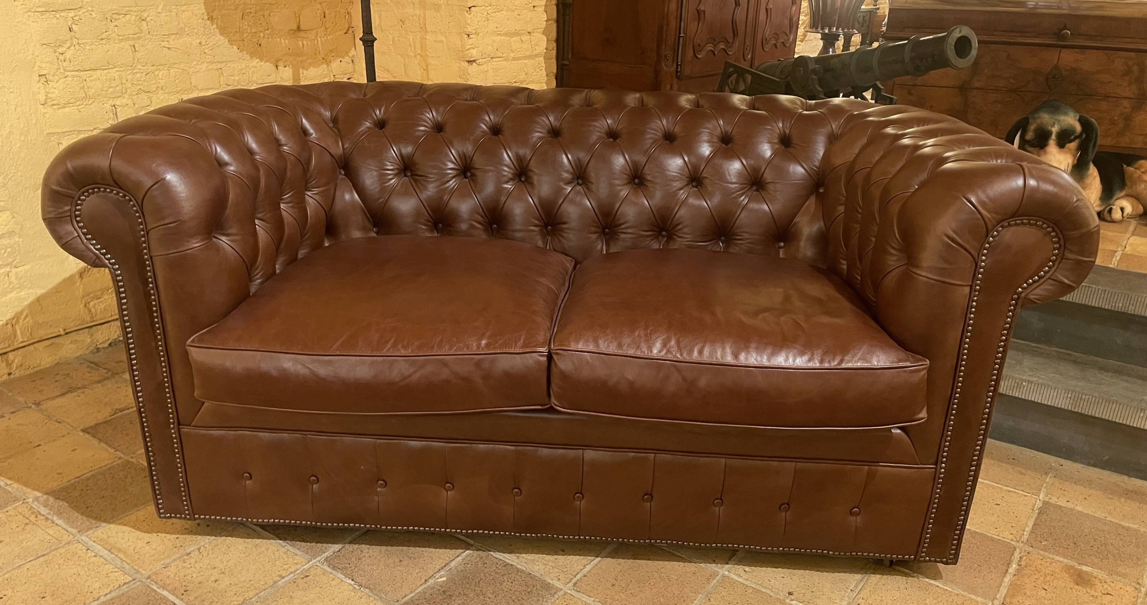 brown leather 2-seater Chesterfield sofa