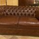 brown leather 2-seater Chesterfield sofa