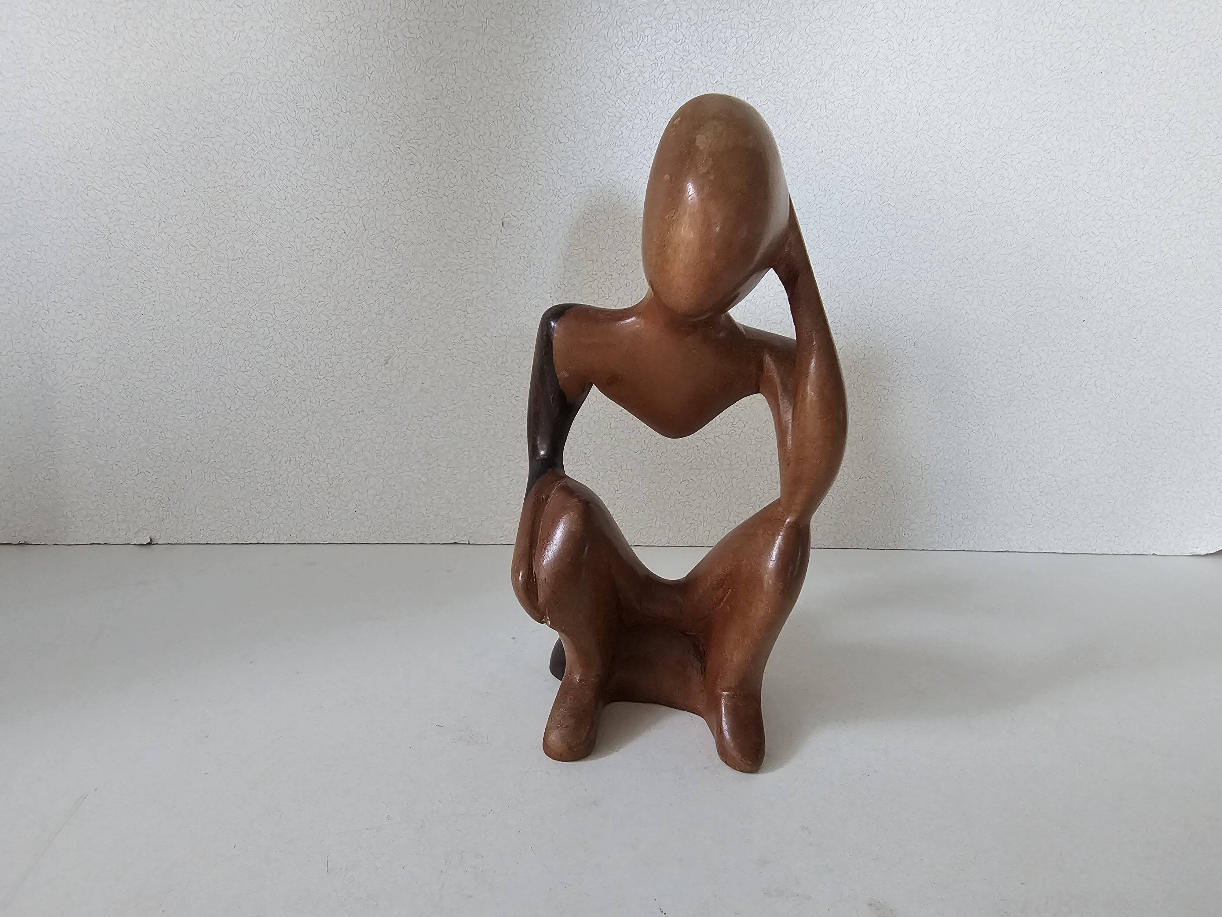 Wooden statuette sculpture of a thinking man design