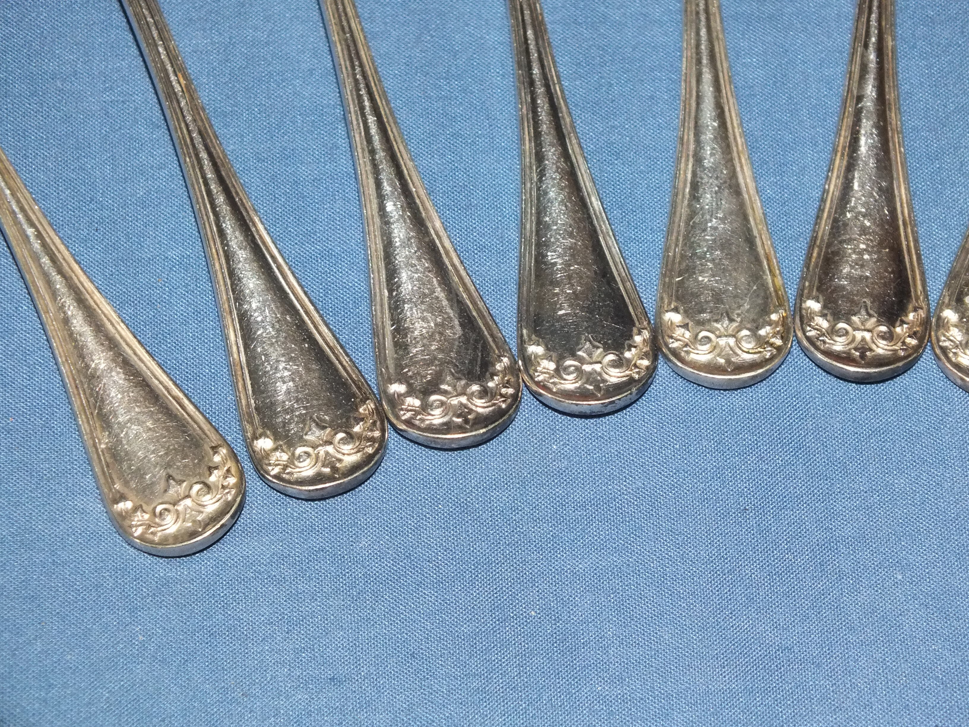 Old box of 12 small white metal spoons