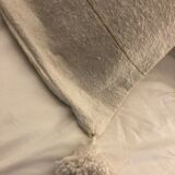 White cushion cover with pom poms