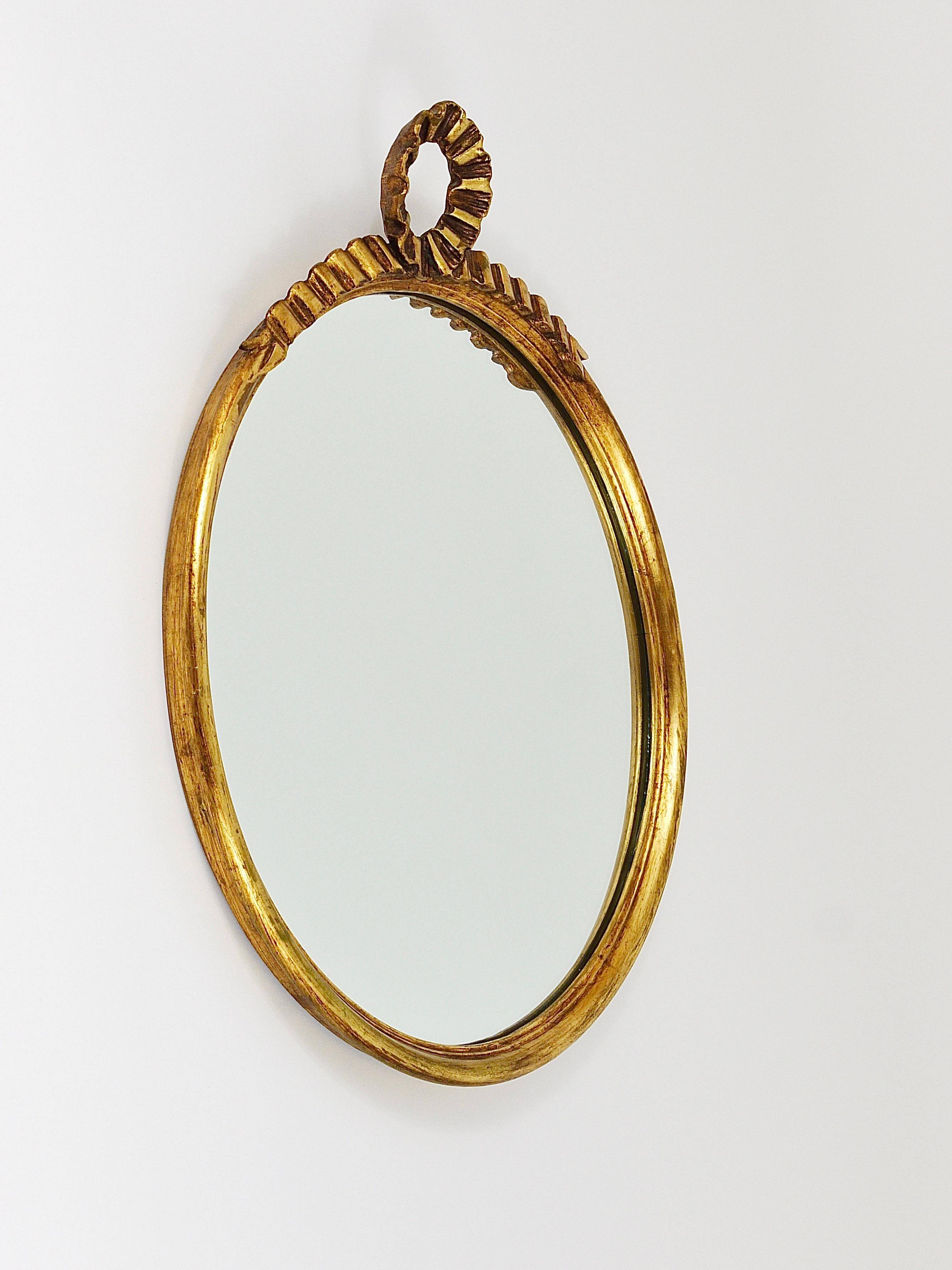 Round wall mirror in gilded wood, mid-century, C. Allodi & G. Subelli, Italy, 1950s.