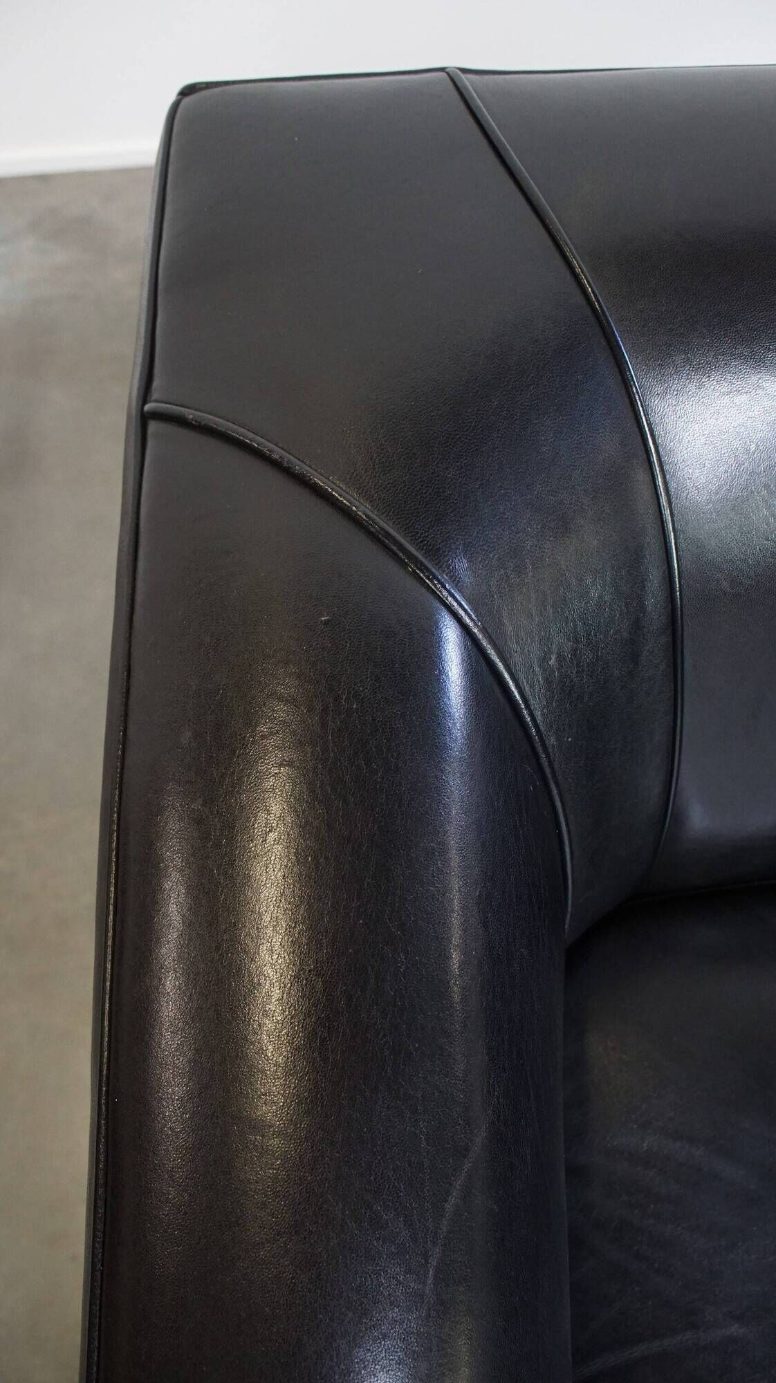 Very comfortable black Art Deco design armchair, made of sheepskin leather
