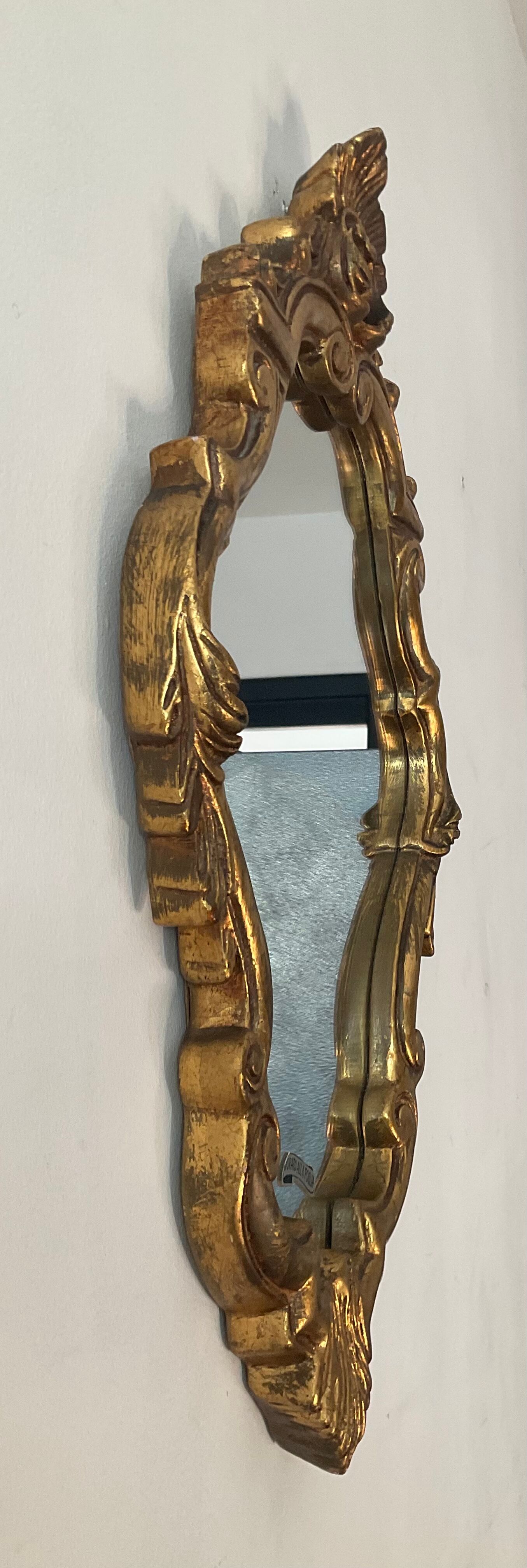 Old italian mirror in gilded plaster with leaf