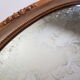 Large oval mirror with bevelled ice in stucque and wood decorated with flowers