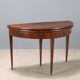 Antique demi-lune console in mahogany with an opening top, 19th century.