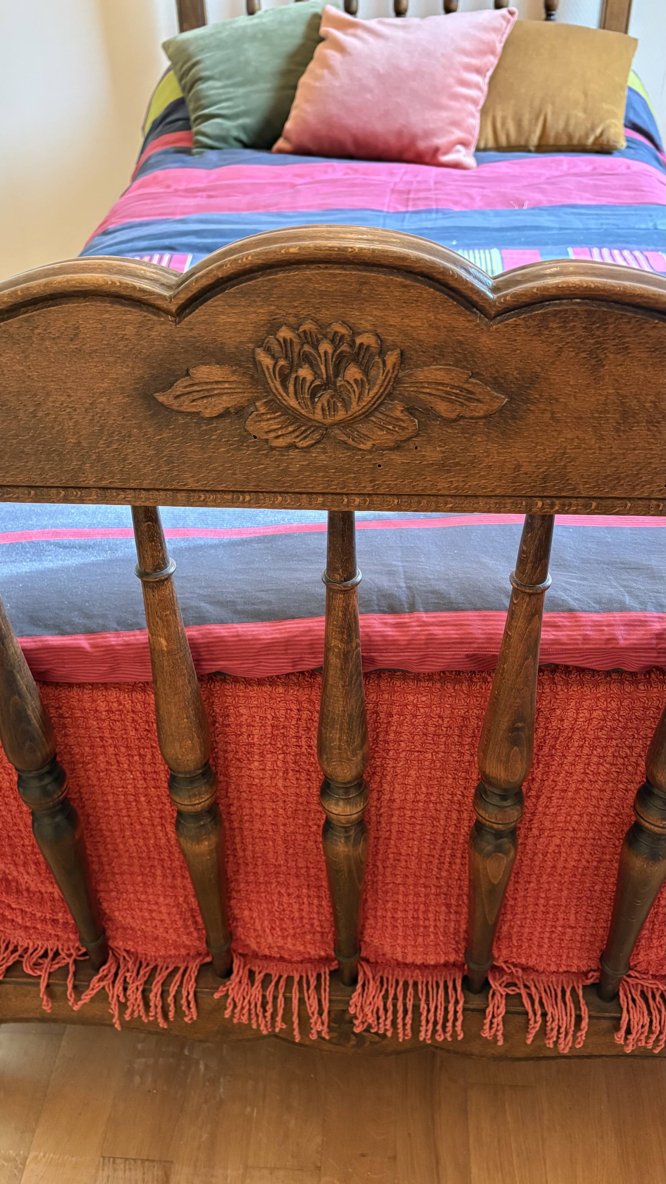 1 bed with a wooden frame and mattress