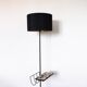 Black metal magazine rack floor lamp with ceramic shelf