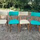 Set of 4 vintage chairs in wood and imitation blue leather dating from the 50s. Wooden structure. Seat and backrest in imitation leather 2 mint green and 2 yellow. Seating dimension: 46 cm. Good state of conservation, some traces of wear.