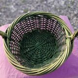 Green wicker basket with a large vintage handle