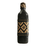 Ethnic decorative bottle in leather and raffia braiding