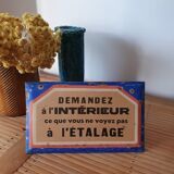 Old enamelled plate of a hardware store