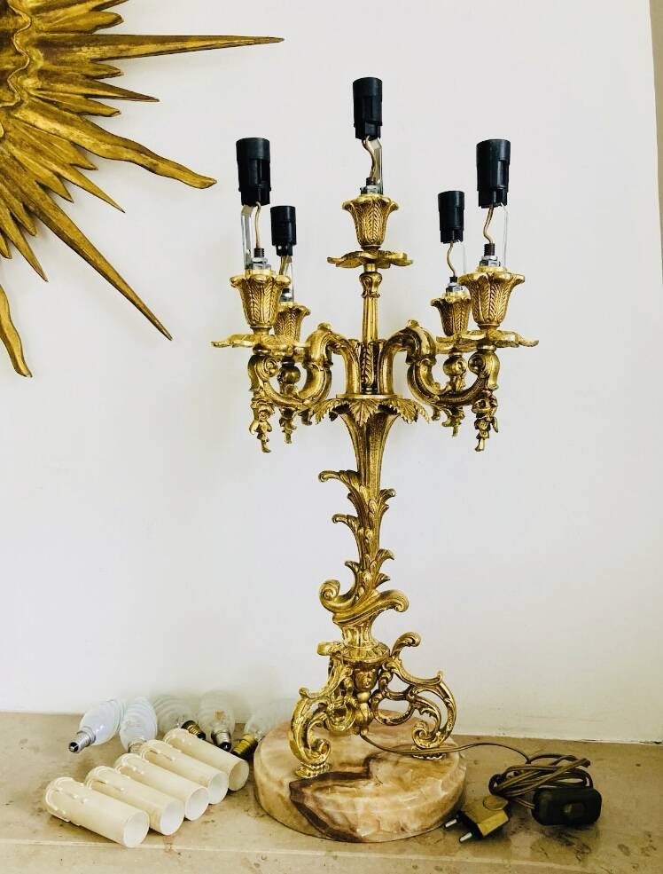 Massive gilded bronze chandeliers from the mid-20th century with marble bases.