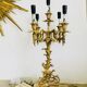 Massive gilded bronze chandeliers from the mid-20th century with marble bases.