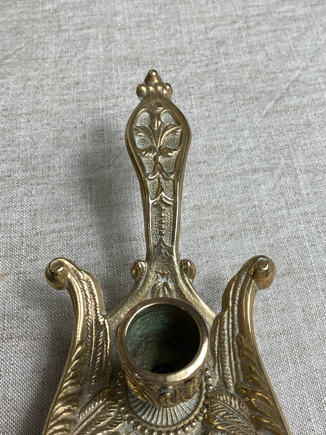 Bronze hand candlestick in the shape of a peacock