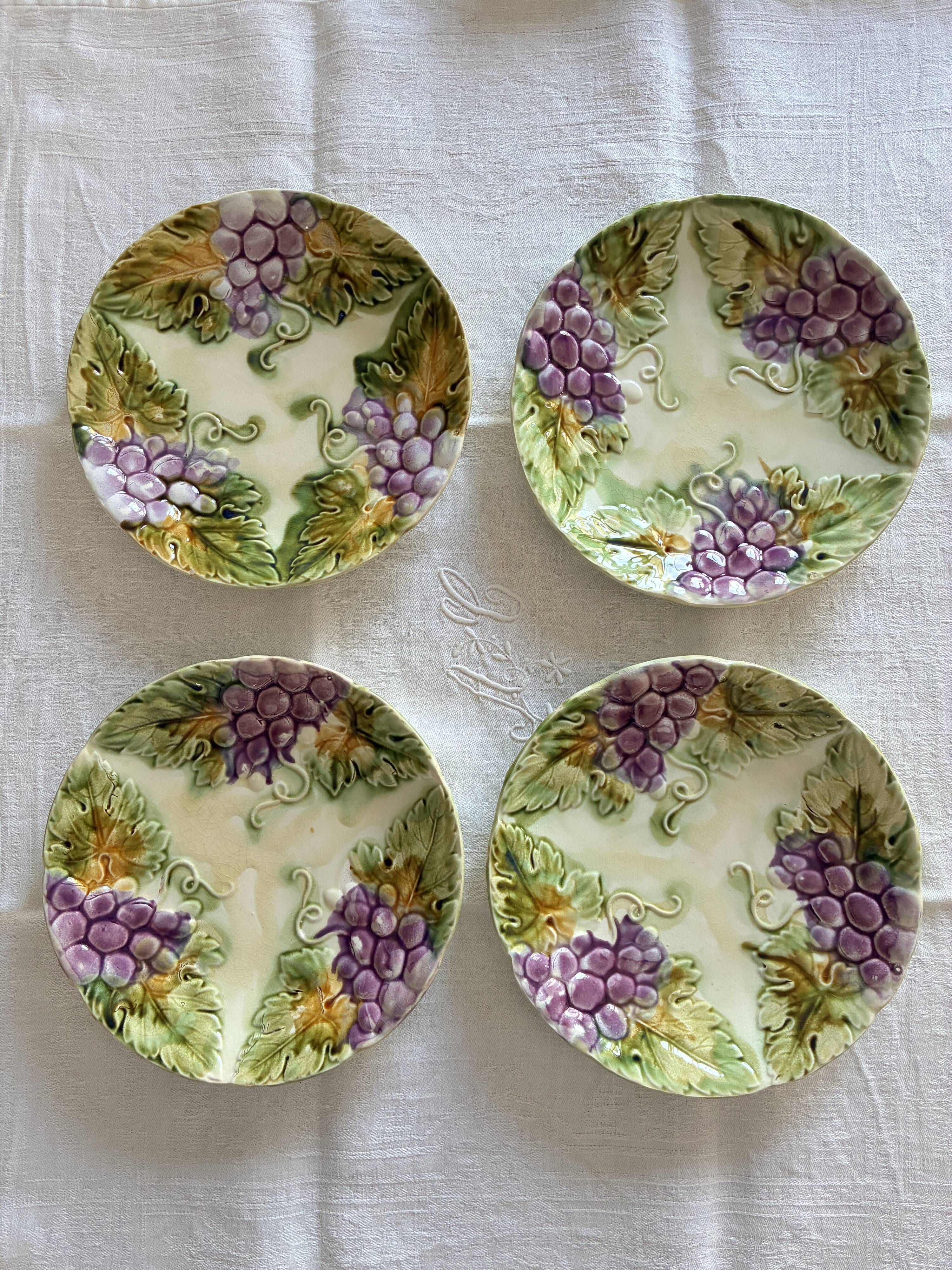 Lot of 4 Onnaing barbotine plates with grapevine design.