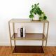 Golden metal shelf and smoked glass