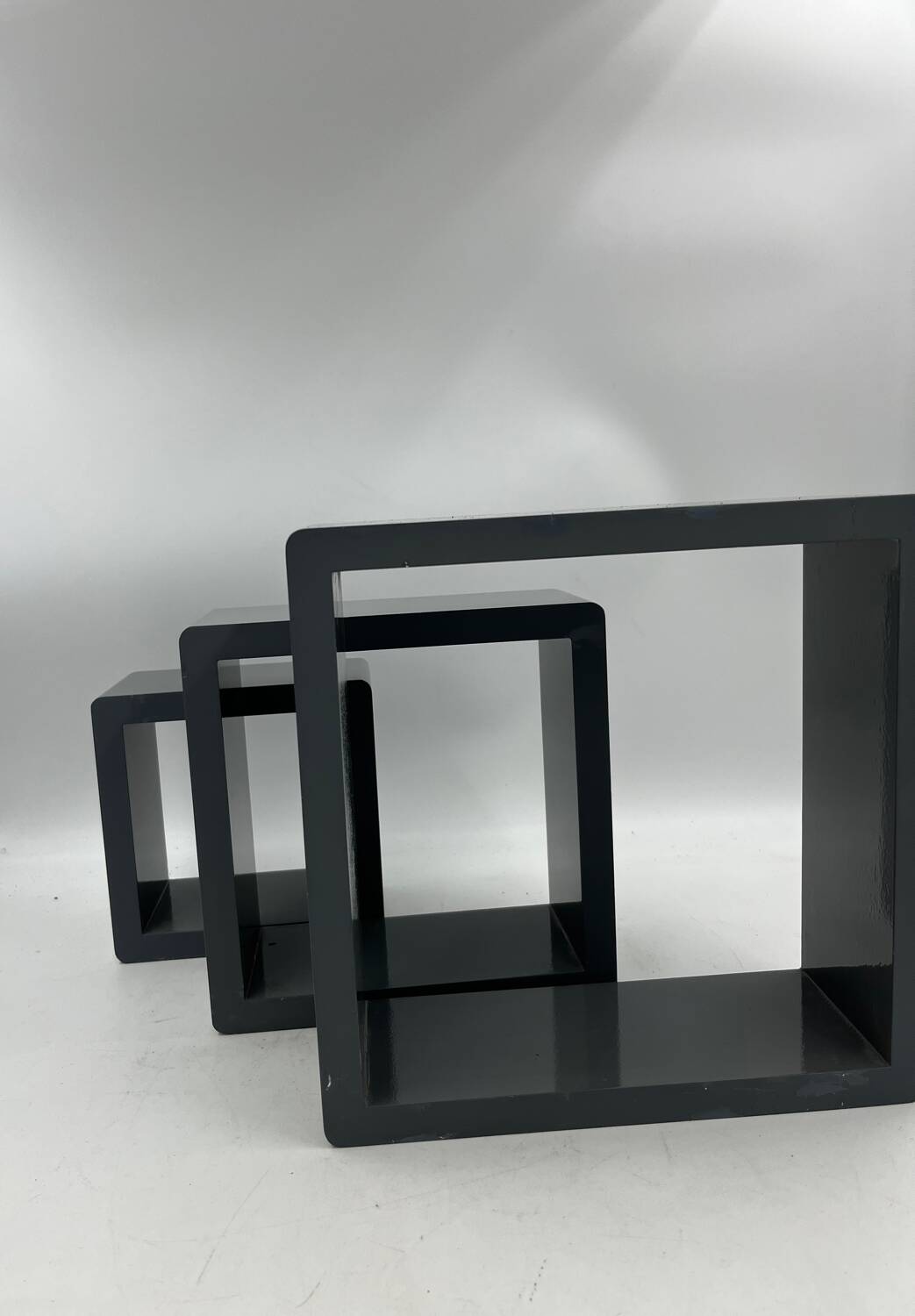 3 nesting shelves in grey lacquer.