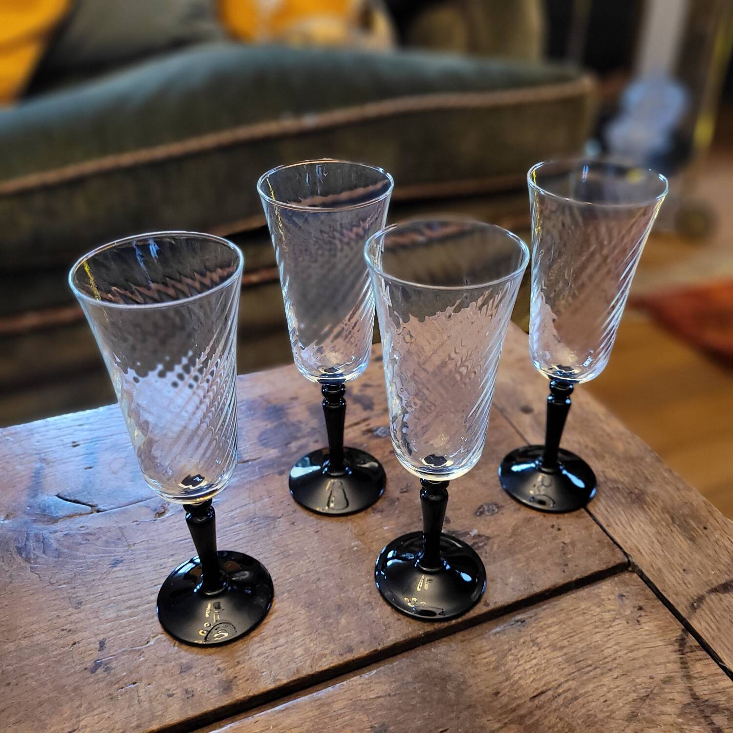 4 clear glass flutes with black stems. 1960–1970. 4 clear glass flutes with black stems.