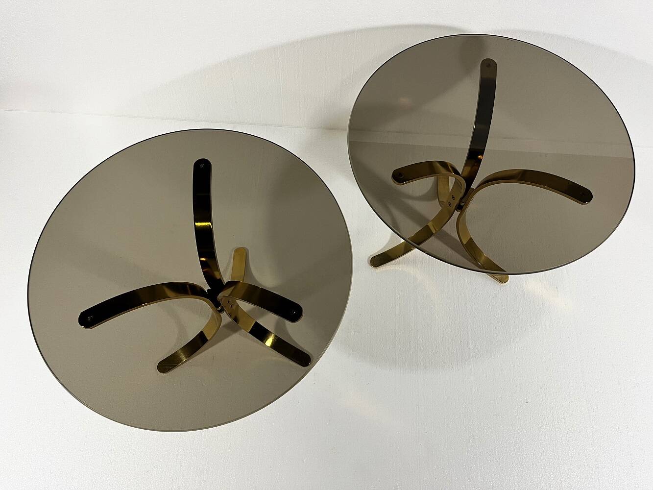 Brass and smoked glass side tables from the 1960s.