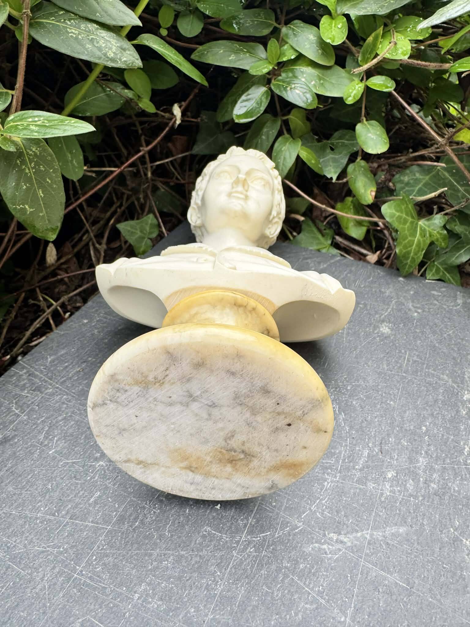 Alabaster bust of a woman signed Arnaldo Giannelli.