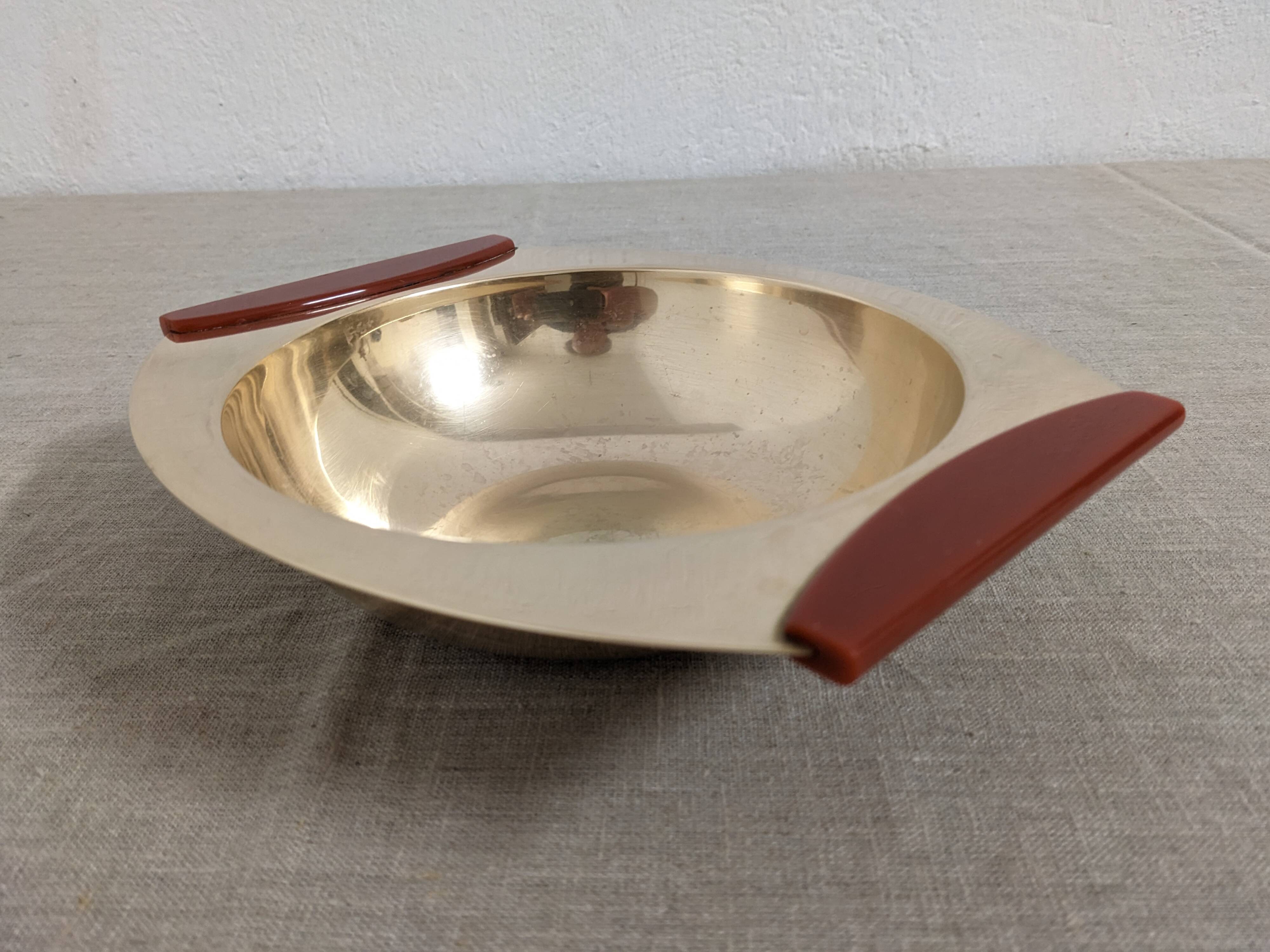 Plates and a brass and Bakelite cut by PM Italy, Italy around 1970.