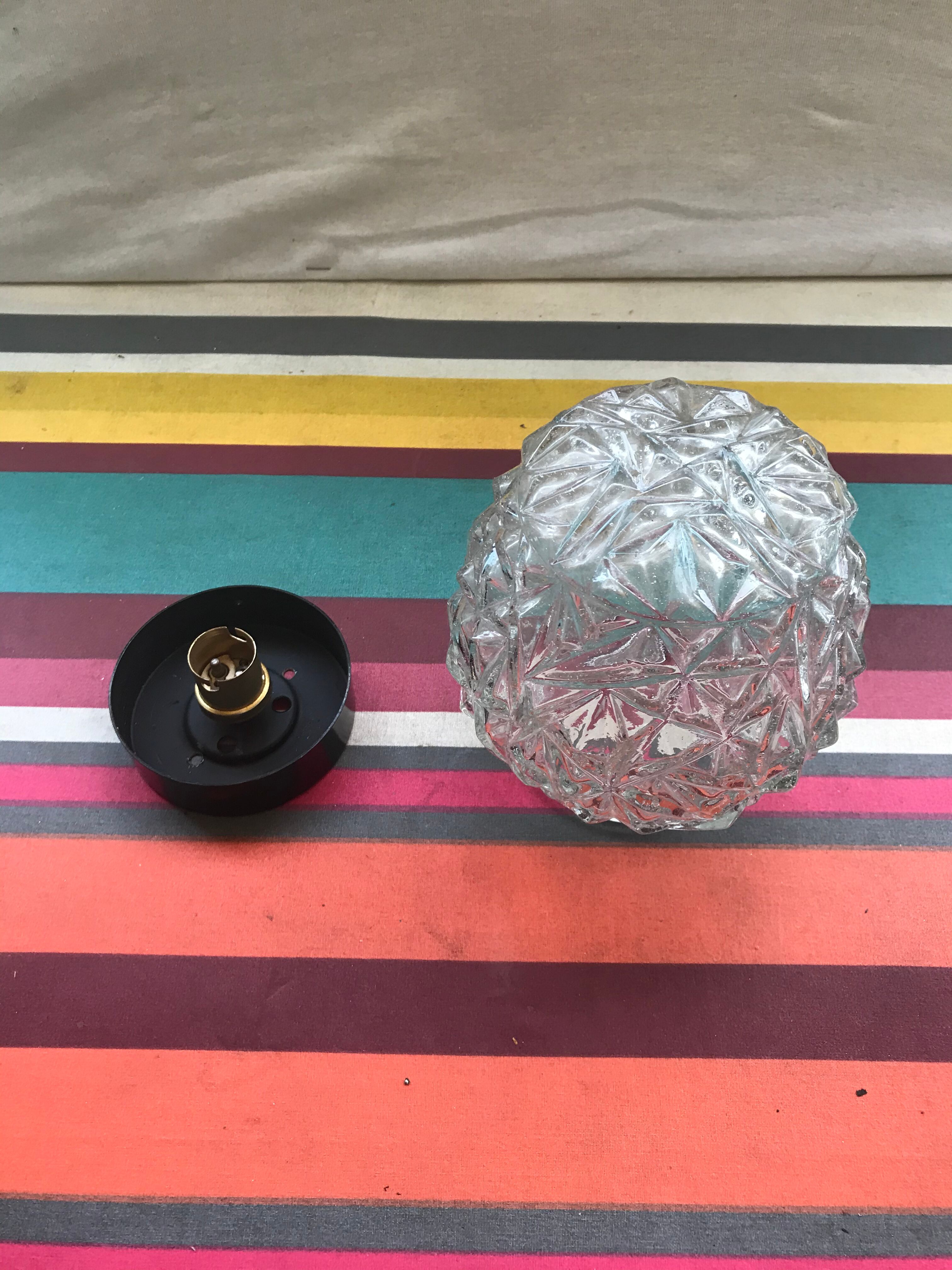 Old pair of glass moulded wall sconces with vintage black metal support