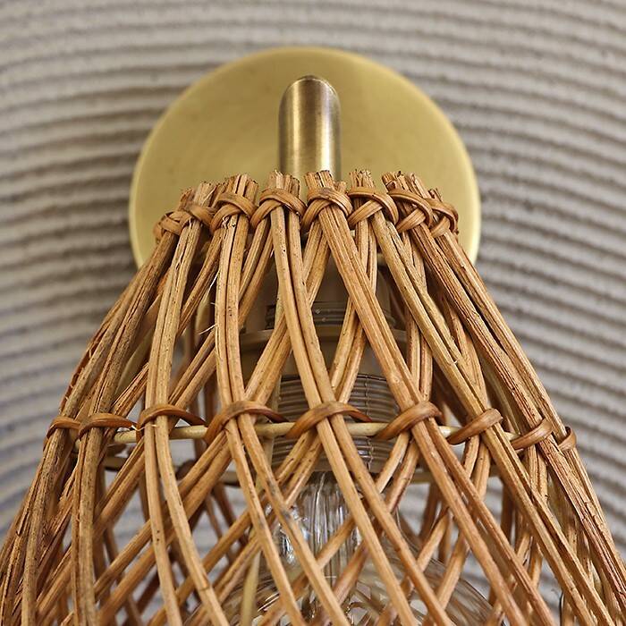 Golden bohemian wall lamp in woven rattan
