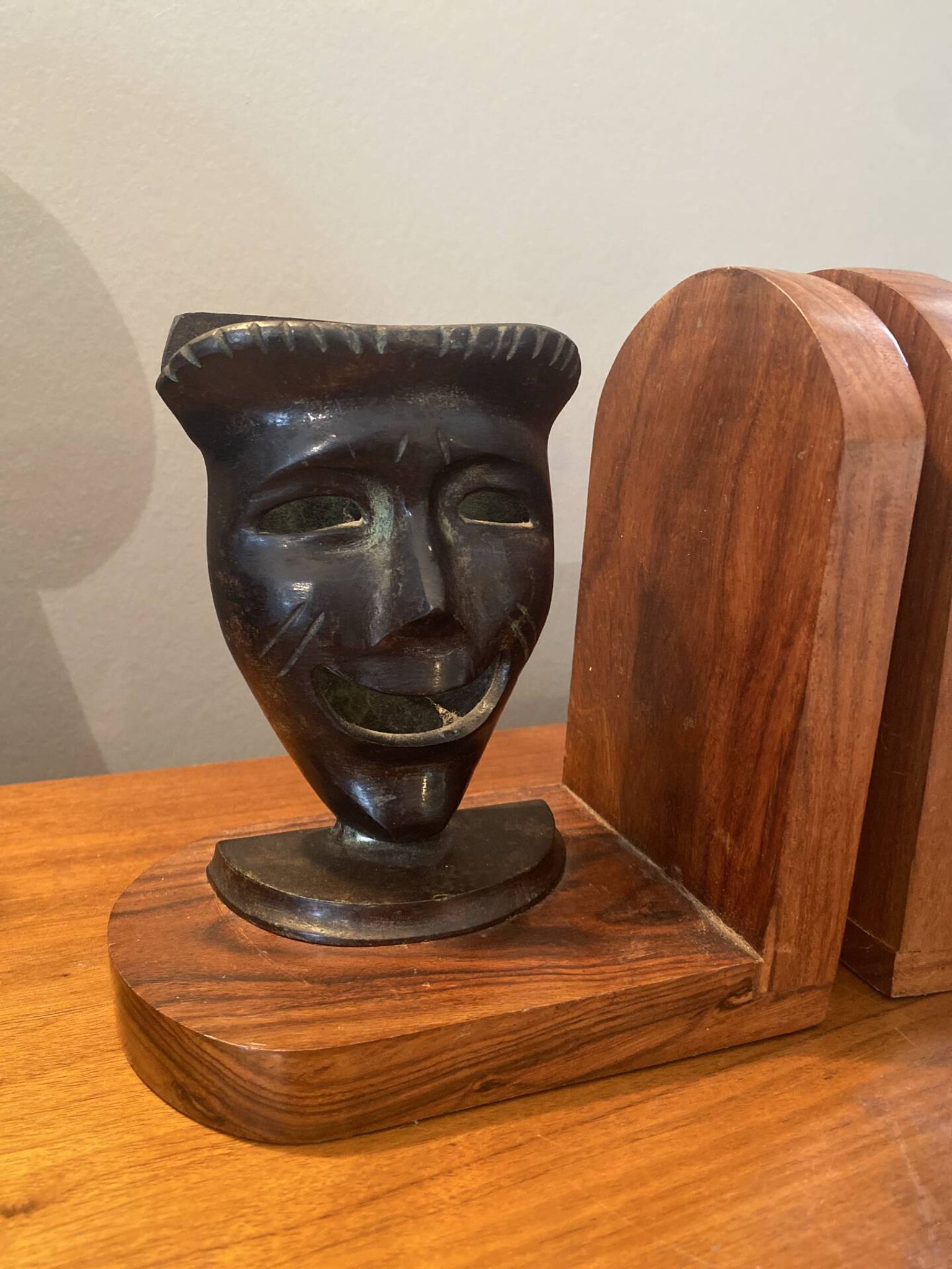 Pair of bronze bookends with masks