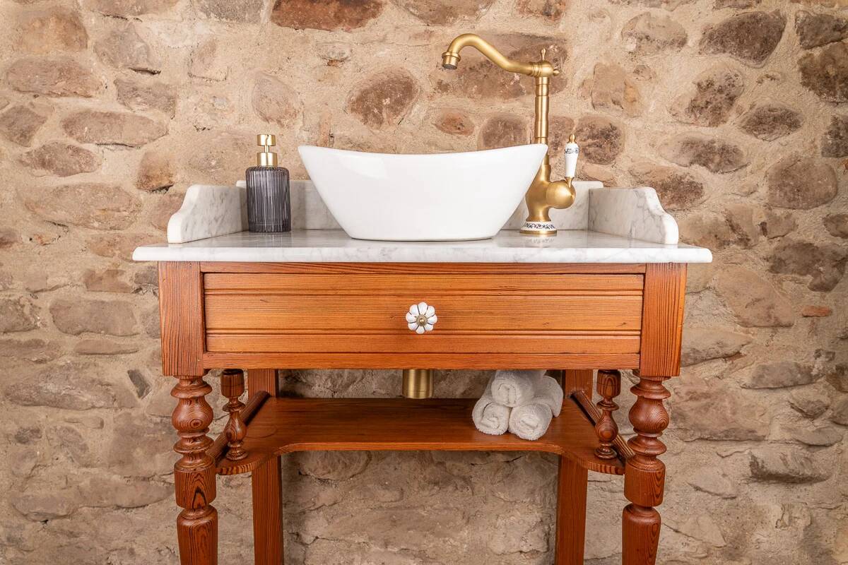 Antique washbasin cabinet in solid pitch pine with a white marble top.