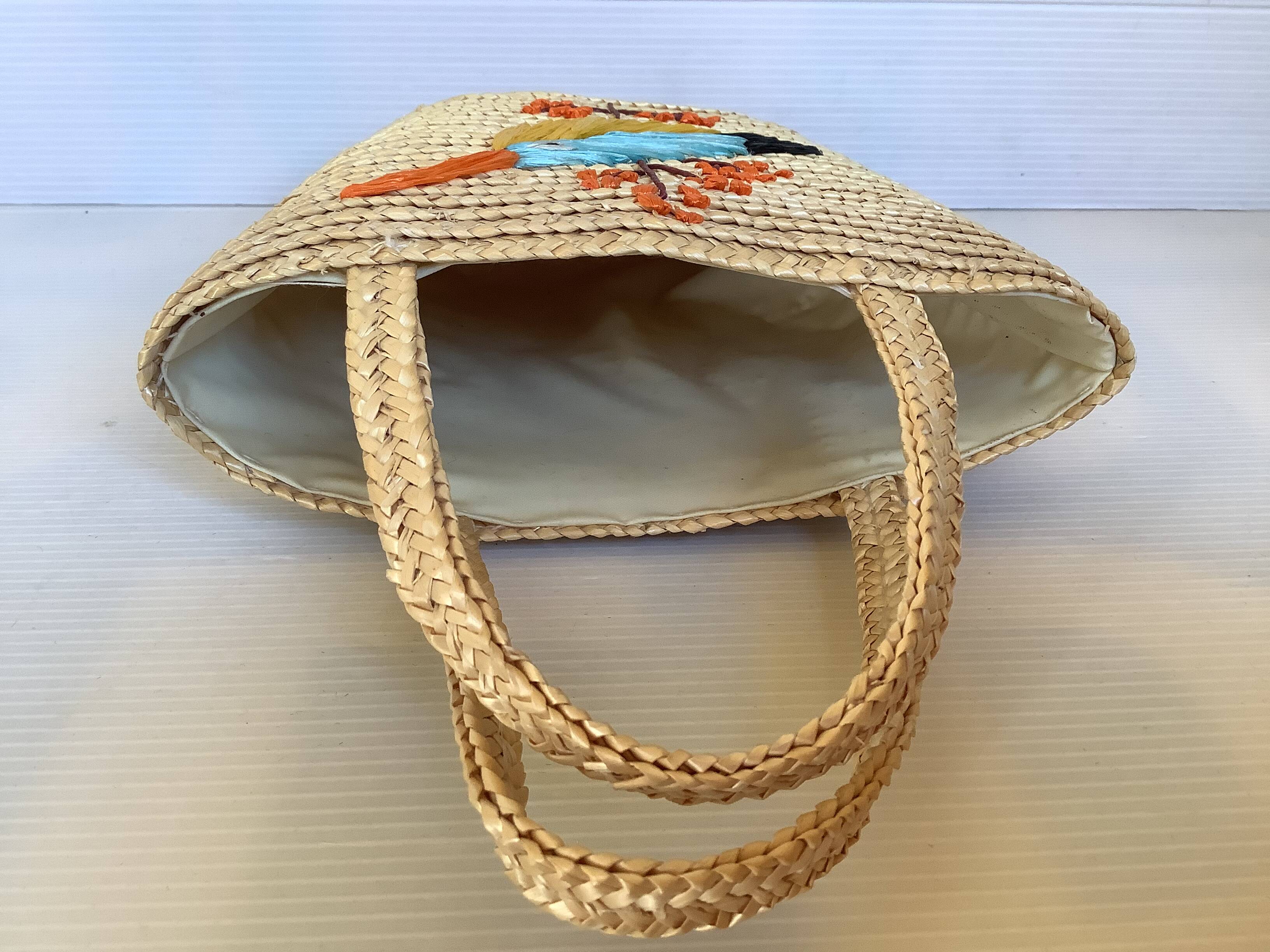 Old woven straw basket embroidered raffia