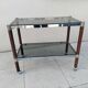 Vintage dessert table in wood, smoked glass, chrome metal, and wood.
