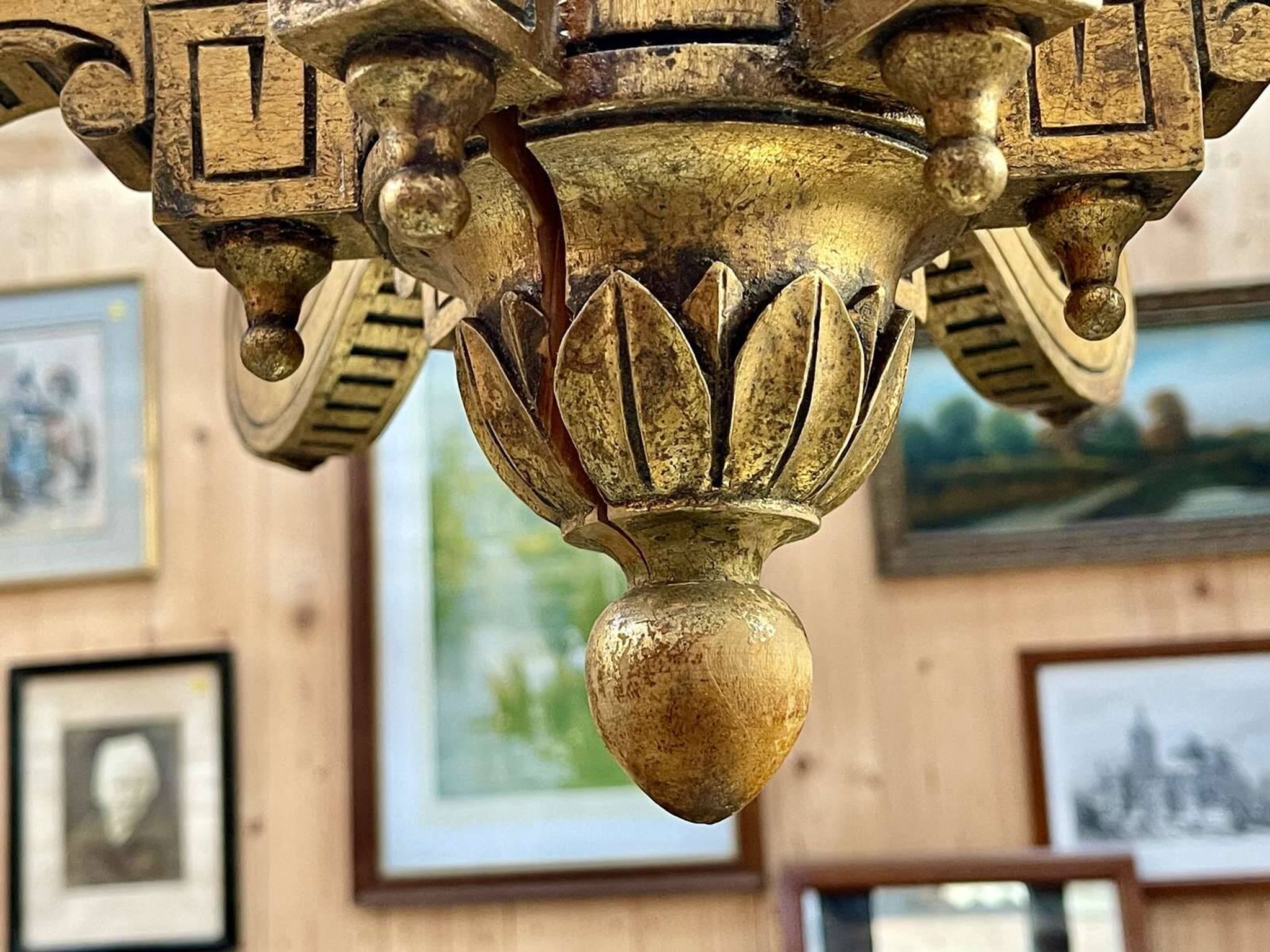 Golden wooden chandelier with crystal pendants from the 19th century.